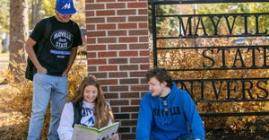 Mayville State University students looking at textbook
