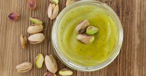 homemade pistachio butter on wooden table