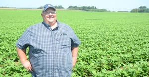 Matt Friend stands in front of one of his green bean fields in Mason County