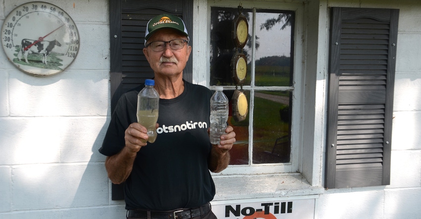 Keith Miller holds two bottles of water