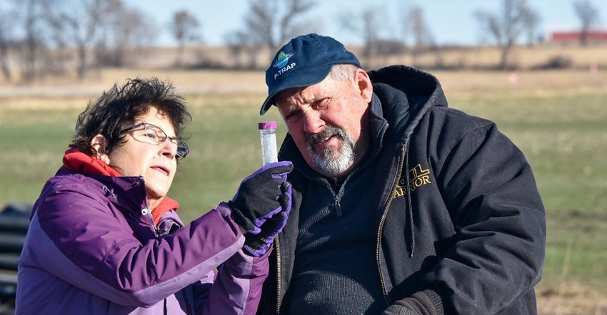 Charlie Hammer and Nancy Kavazanjian gather a water sample 