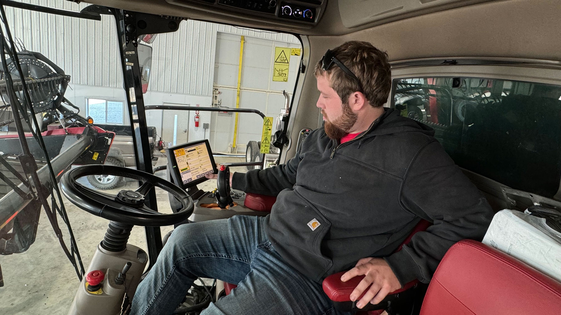 Jessup Hunt checks on technology inside the cab of the combine