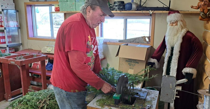 Rex Miller makes roping from Frasier fir branches in his gift shop 