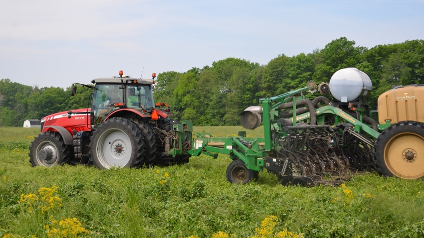 tractor and planter planting into cover crop