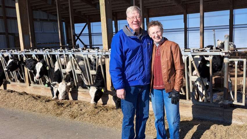 2023 Wisconsin Master Agriculturists Eric and Carol Hillan with dairy cows at feeder in the background 2023 Wisconsin Master Agriculturists Eric and Carol Hillan with dairy cows at feeder in the background