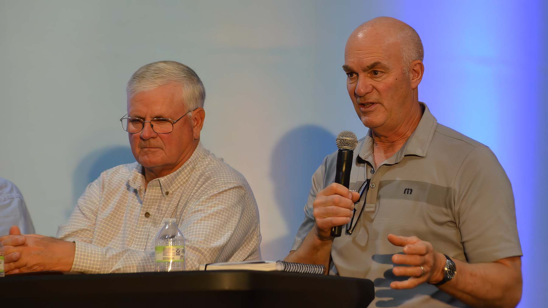  Iowa farmer Mark Mueller (right) explains how fertilizer industry consolidation has impacted his operation, as Arkansas farmer Joe Mencer listens. 