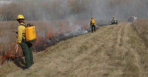 A fire crew watches over a prescribed burn in North Dakota. 