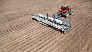 An aerial view of a tractor planting crop seeds