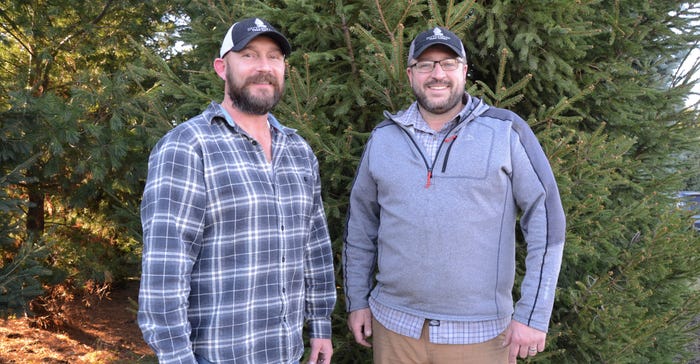 Co-owner Chris Maciborski (left) and nursery manager Scott Powell infront of Scotch pines.