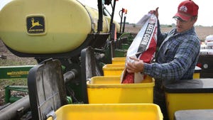 Farmer filling planter with corn seed