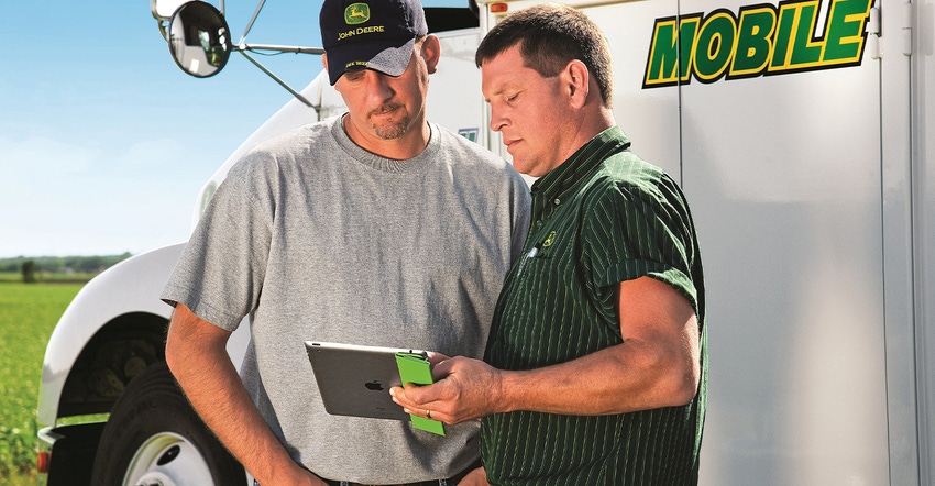 Deere client with Deere support person looking at tablet