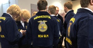 FFA members standing with their backs to the camera in blue FFA jackets