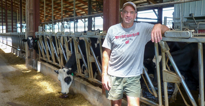 Jerry Zander posing in front of dairy cows Jerry Zander posing in front of dairy cows