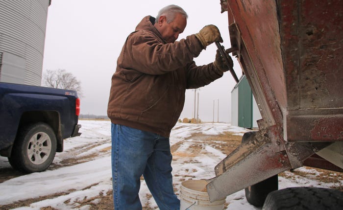 2020 Master Farmer Dale Hadden loading feed into bucket from gravity wagon