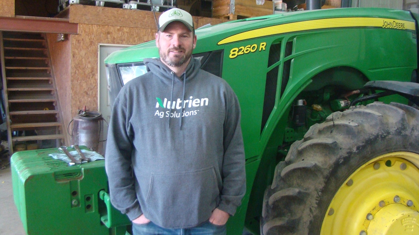 Tom Murphy standing in front of John Deere tractor