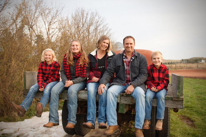 Pictured are Doug and Janelle Fitterer with their kids, Sierra, Samantha and max all sitting on the bed of an old truck