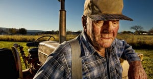 Older farmer and tractor