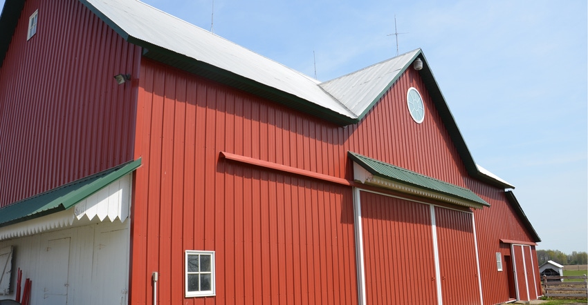 exterior shot of red barn against blue sky