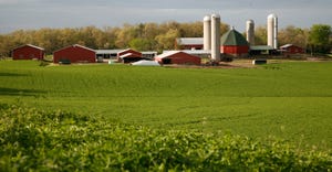 scenic farmstead with red barns and silos