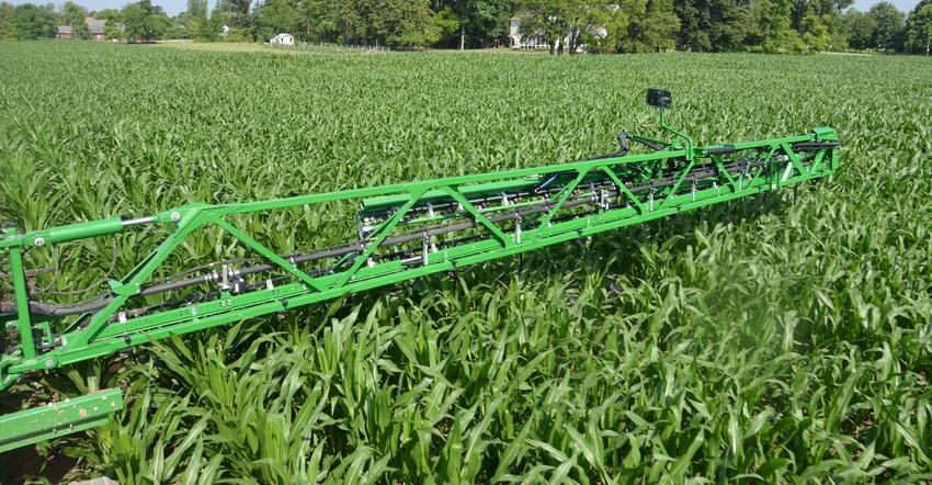 sprayer applying nutrients with Y-drop nozzles just under the canopy
