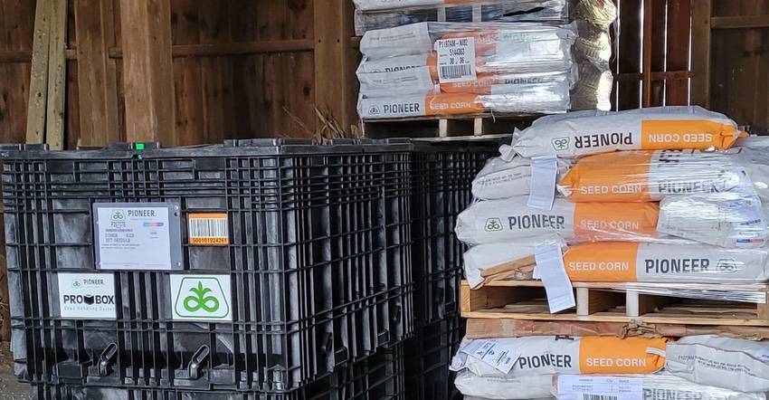 bags of corn seed stacked in barn