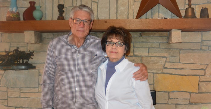 The MCGraws infront of the stone wall that surrounds their fireplace