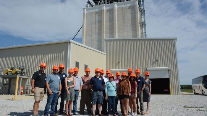 group wearing orange hard hats touring University of Illinois Feed Technology Center