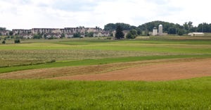 farmland bordering a housing development