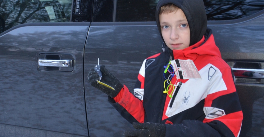 10-year-old Graham holding keys for Ford truck