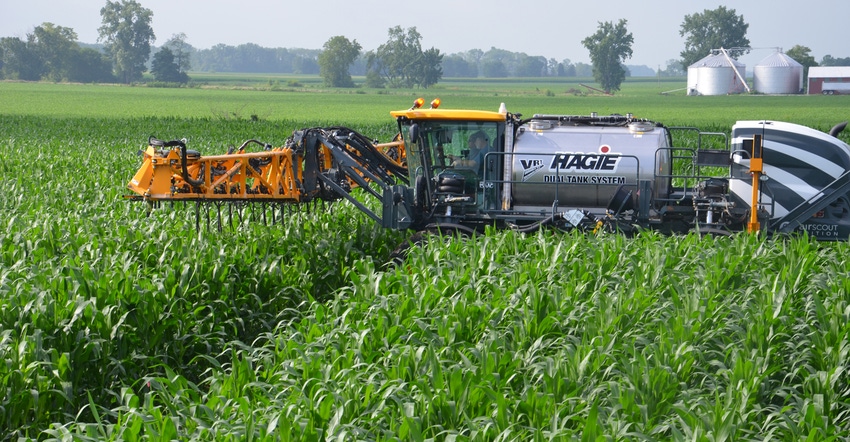 Hagie sprayer applying nitrogen in cornfield Hagie sprayer applying nitrogen in cornfield