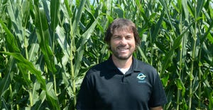 Brandon Hunnicutt standing in front of corn stalks