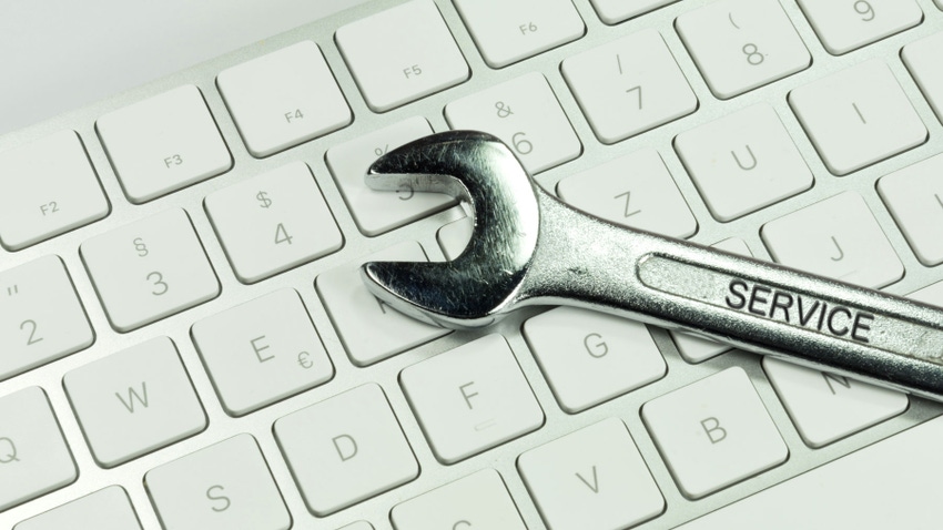 A wrench on a computer keyboard A wrench on a computer keyboard