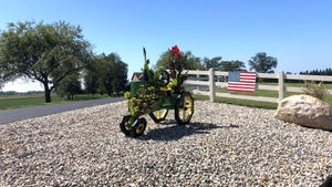 A pedal tractor on display decorated with florals