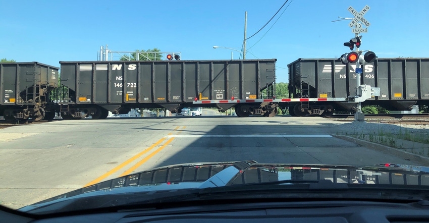 car sitting in front of train tracks