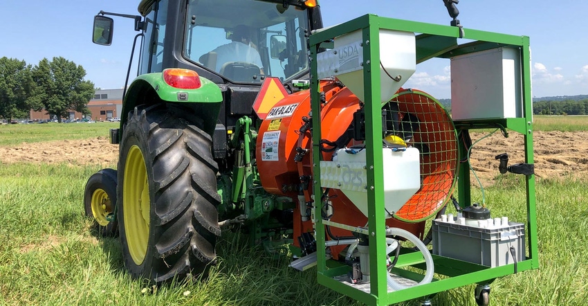 A sprayer system attached to a farm tractor
