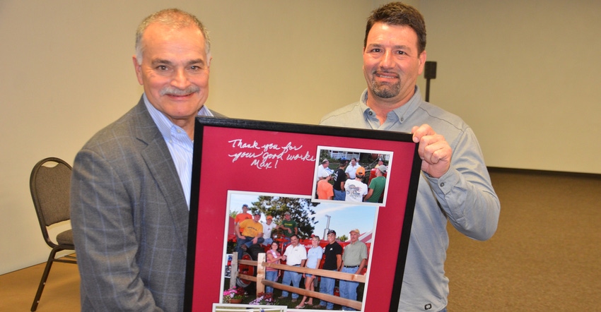 Jim Hess presents Max Armstrong with framed photos