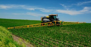 tractor applying pesticide in field
