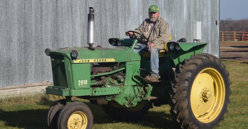 Donald Strabel sitting on 1961 John Deere 2010 tractor