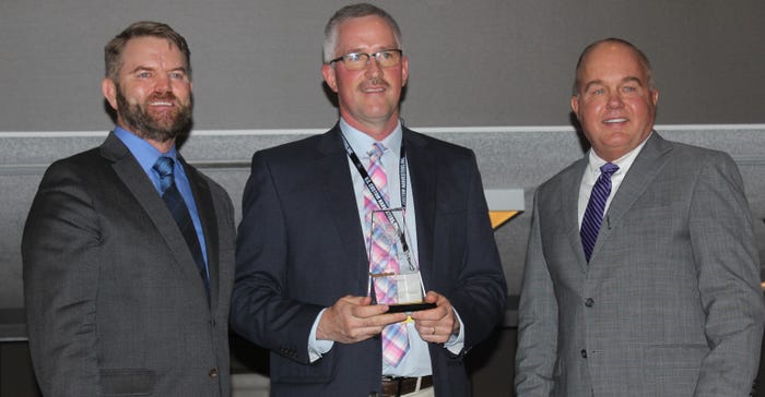Chanler Goupe and David Cloeavinger present Jeff Krohn of Owendale, Mich., with the award from the National Wheat Foundation’s Wheat Yield Contest 