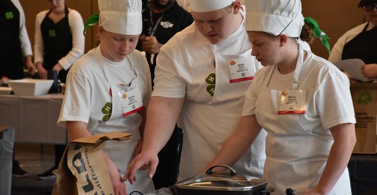 Tennessee 4-Hers, Evelyn Terrell, David Terrell and Rachel Chandler contemplate their ingredients during the 2022 food challe Tennessee 4-Hers, Evelyn Terrell, David Terrell and Rachel Chandler contemplate their ingredients during the 2022 food challe
