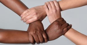 Caucasian and African American hands holding together 