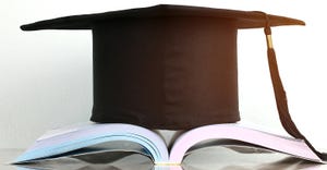 graduation cap on stack of books