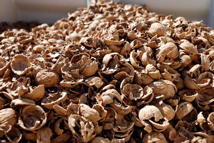 crushed walnut shells on old Jute sack to be used as fertilizer for plants.  decomposing walnut shells release nutrients such as iron. zinc, potassium,  sodium and phosphorous Food Images