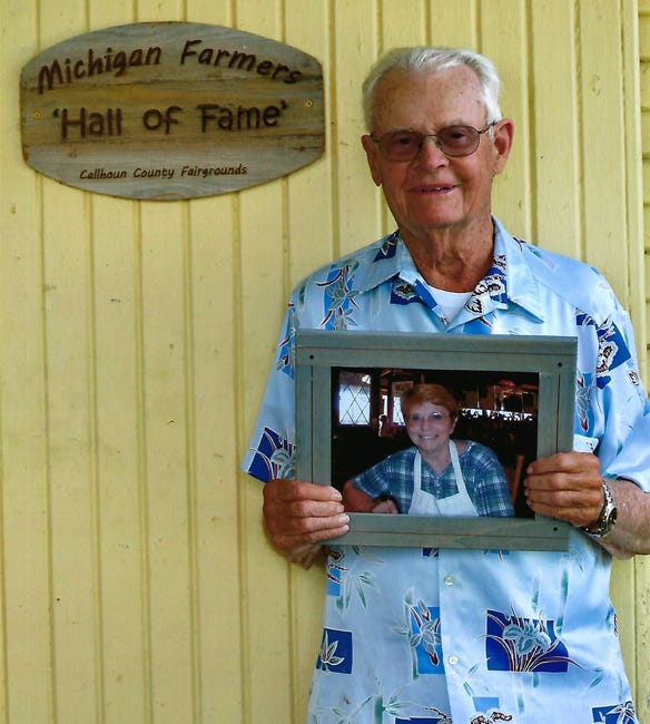 Robert Crane holds a pictured of his late wife, Luetta