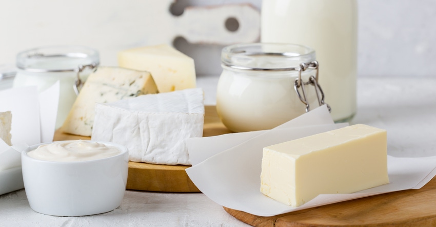 Dairy products displayed on cutting boards on a table