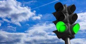green traffic light concept; green go signal on blue sky background