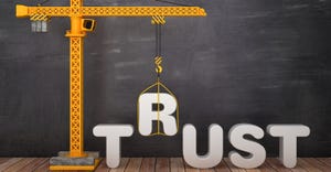 building the word trust with crane - with chalkboard in background