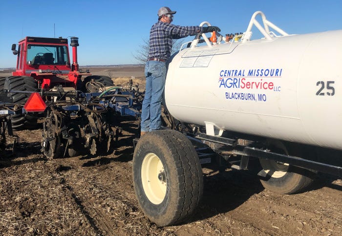Jacob Dierking checking anhydrous tank