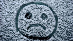 sad face drawn in snow