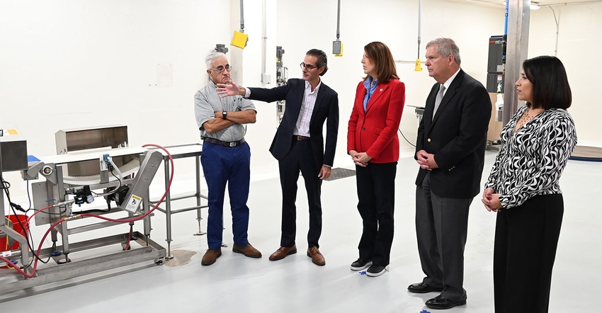 People standing and talking in egg facility